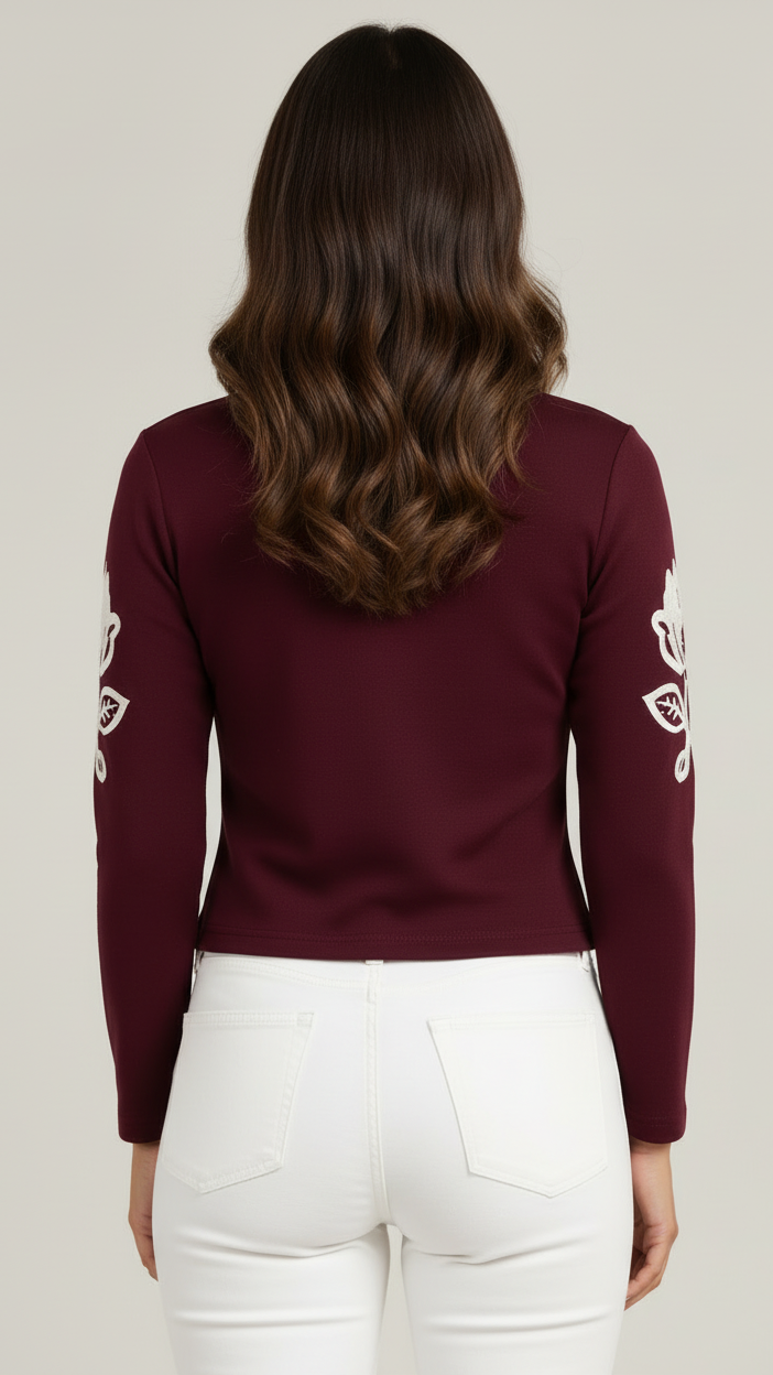 Back view of model wearing EBK Female maroon long-sleeve top showing clean tailoring