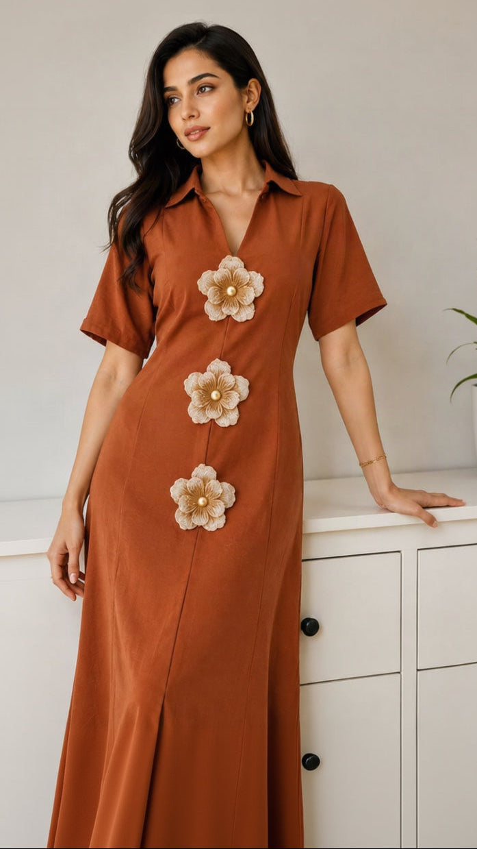 EBK FEMALE rust-orange midi dress with a shirt collar, V-neck, and three beige 3D floral appliqués with pearl centers.